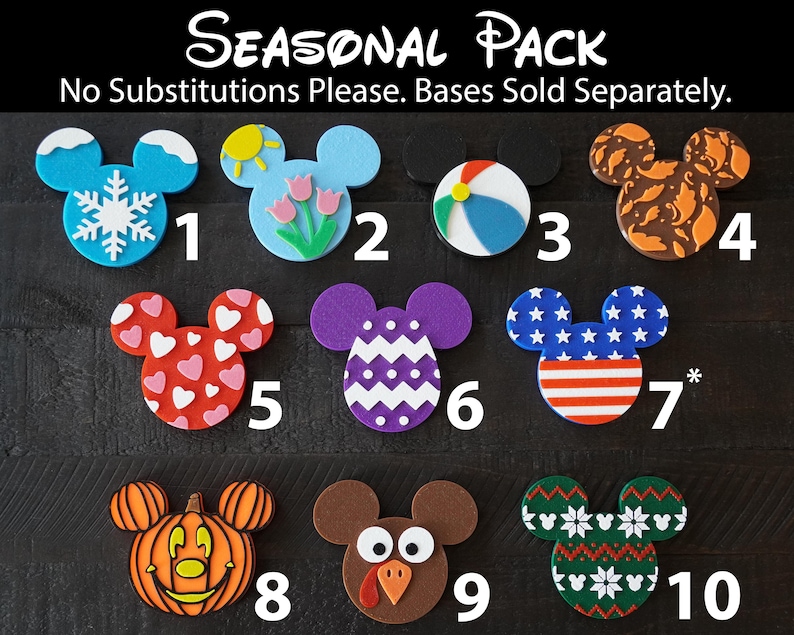 May include: A set of ten Mickey Mouse-shaped ornaments with different seasonal designs. The ornaments are numbered 1 through 10. The designs include a snowflake, a sun, a beach ball, fall leaves, hearts, a chevron pattern, an American flag, a pumpkin, a turkey, and a snowflake pattern.