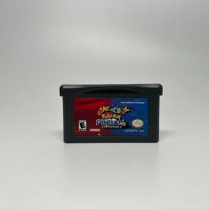 May include: Black Nintendo Game Boy Advance cartridge for Pokémon Pinball: Ruby & Sapphire. The cartridge has a red and blue label with the game title and various Pokémon characters. The game is rated E for Everyone.