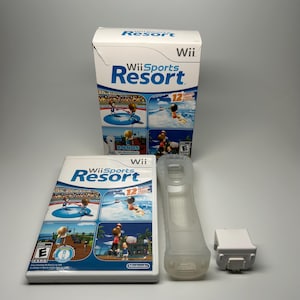 May include: A complete Wii Sports Resort game set. The box and game case feature the game's logo and graphics of various sports activities. Includes a white remote, a remote sleeve, and a sensor bar.