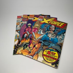 May include: A stack of comic books featuring the X-Force team. The top comic is a special edition featuring the first appearance of the team. The cover features a group of superheroes in action, including a large, blue, muscular character with a gun.