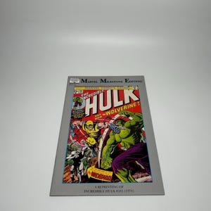 May include: A comic book cover featuring The Incredible Hulk and Wolverine in a battle scene. The cover has a red, yellow, and green color scheme with the text "The Incredible Hulk" and "Wolverine!" The comic is a reprint of Incredible Hulk #181 (1974).