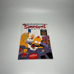 May include: A Simpsons Comics comic book. The cover features Homer Simpson with his mouth open, surrounded by other characters. The comic book has the text "FIRST ISSUE COLLECTOR'S ITEM!" and "GIANT SIMPSONS PULL-OUT POSTER INSIDE!"