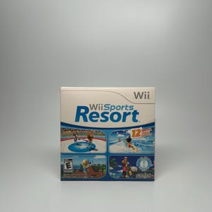 May include: Wii Sports Resort game box. The box is white with the game title in blue and features images of various sports activities. The game is rated E for Everyone and includes 12 sports.
