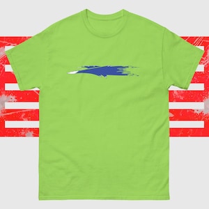 May include: A lime green t-shirt featuring a blue and white abstract design across the chest. The background includes a distressed red and white graphic. The shirt has short sleeves and a crew neck.