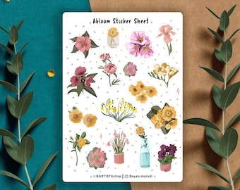 Pode incluir: Uma folha de autocolantes florais com várias ilustrações de flores em aquarela em rosa, amarelo e roxo. A folha de autocolantes tem o texto "Abloom Sticker Sheet" e nomes de mídia social.