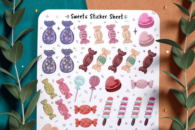 May include: A sticker sheet with a variety of colorful candy and sweet treats. The sheet includes candy canes, lollipops, chocolate hearts, and wrapped candies. The text "Sweets Sticker Sheet" is printed at the top of the sheet.