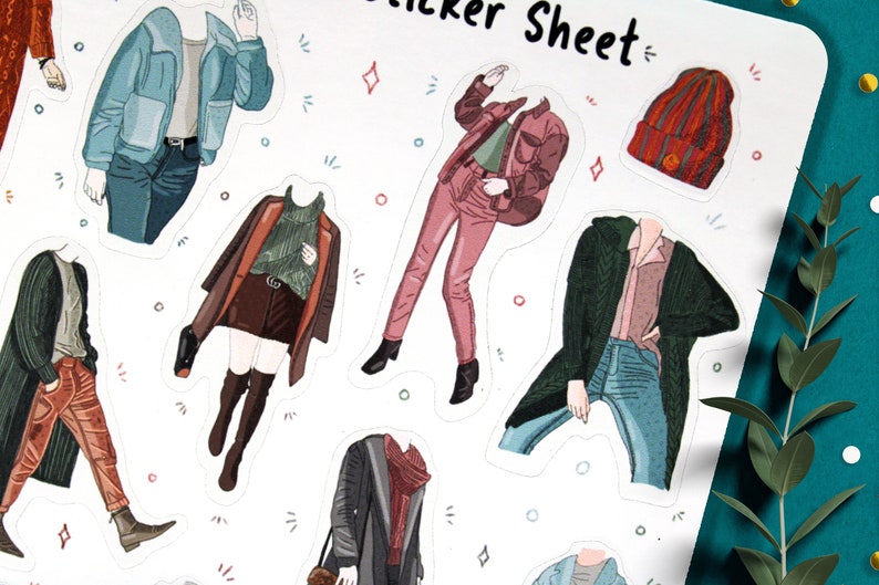 May include: A sticker sheet with illustrations of people wearing different outfits. The outfits include a blue jacket, a red jacket, a green cardigan, a brown coat, and a black coat. The sticker sheet also includes a red beanie.