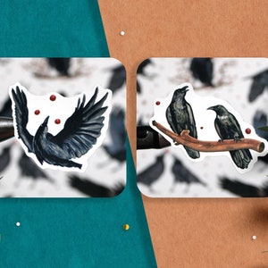 May include: Two black crow stickers on a white background. One crow is flying with red dots around it. The other two crows are perched on a branch.