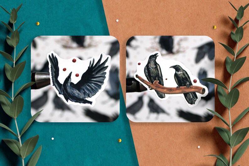 May include: Two black crow stickers on a white background. One crow is flying with red dots around it. The other two crows are perched on a branch.