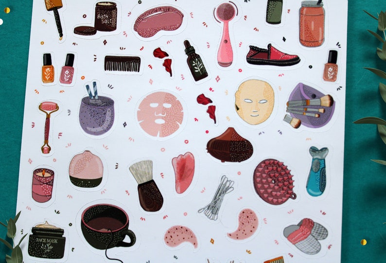 May include: A set of colorful stickers featuring various beauty and self-care items, including face masks, bath salts, brushes, and a facial cleansing brush. The stickers are on a white background with pink and orange accents.