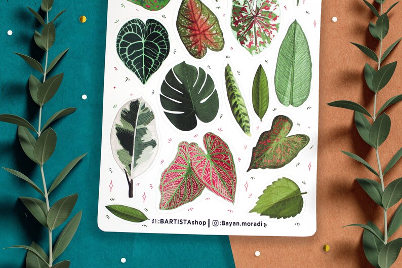 May include: A sheet of stickers featuring various green and pink tropical leaves. The stickers are on a white background with pink and white accents. The text '#BARTISTAShop | @Bayan.moradi' is at the bottom of the sheet.