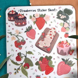 May include: A sticker sheet with a white background featuring various illustrations of strawberries, cakes, and flowers. The text "Strawberries Sticker Sheet" is printed at the top of the sheet.