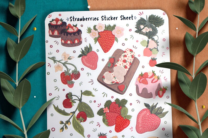 May include: A sticker sheet with a white background featuring various illustrations of strawberries, cakes, and flowers. The text "Strawberries Sticker Sheet" is printed at the top of the sheet.