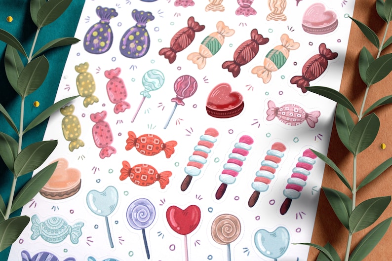 May include: A sheet of colorful candy stickers with various shapes and designs, including lollipops, hearts, and wrapped candies. The stickers are on a white background.