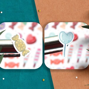 May include: Two white square stickers with a colorful candy background. The left sticker features a cartoon illustration of a yellow and brown wrapped candy. The right sticker features a cartoon illustration of a blue heart-shaped lollipop.