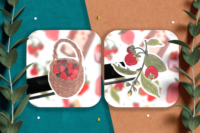 May include: Two stickers featuring illustrations of strawberries. One sticker shows a wicker basket overflowing with red strawberries. The other sticker shows a branch of green leaves with red strawberries.