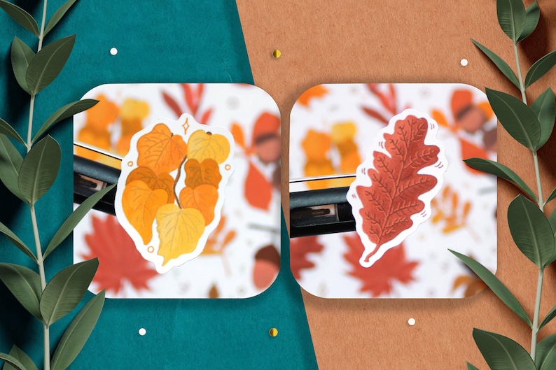 May include: Two autumn-themed stickers featuring a cluster of yellow and orange leaves and a single red oak leaf.