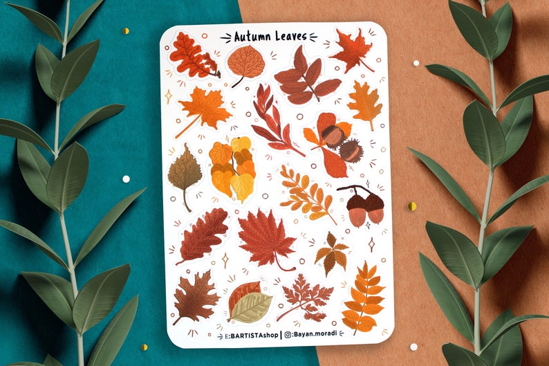 May include: A sheet of stickers featuring various autumn leaves in shades of orange, red, yellow, and brown. The stickers are arranged in a random pattern on a white background. The text "Autumn Leaves" is printed at the top of the sheet. The text "@Bayan.moradi" is printed at the bottom of the sheet.