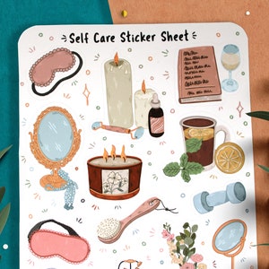 May include: A sticker sheet with illustrations of self-care items, including a sleep mask, candles, a book, a glass of wine, a face roller, a cup of tea with lemon, a dumbbell, a bath brush, a mirror, and flowers.