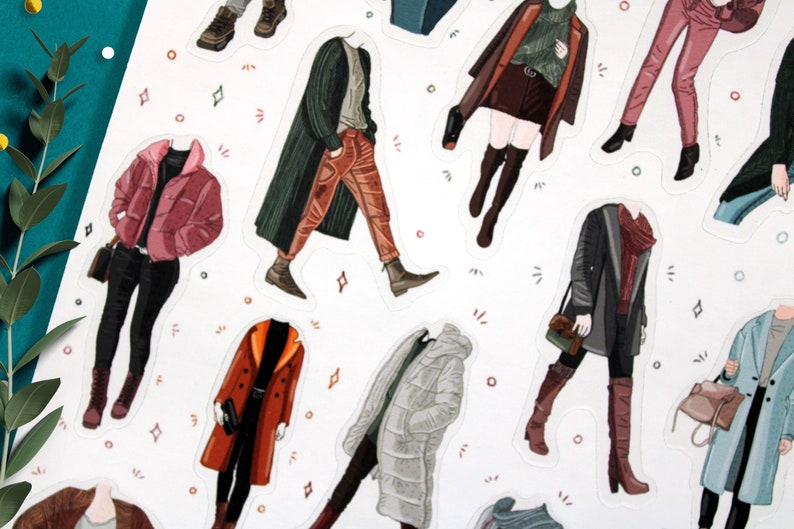 May include: A set of 10 illustrated stickers featuring different outfits for paper dolls. The stickers are printed on white paper and feature a variety of colors and patterns.