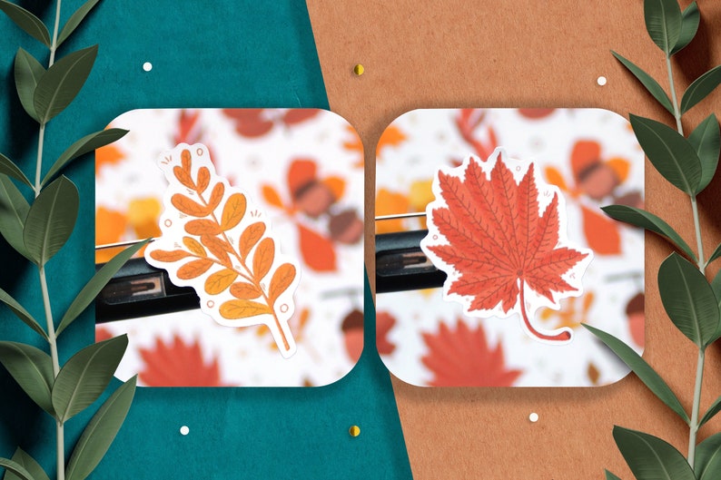 May include: Two autumn-themed stickers, one with a branch of orange and yellow leaves and the other with a red maple leaf.