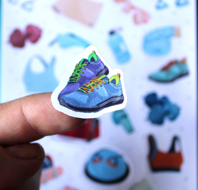 May include: A sticker of two blue and green athletic shoes with a white background.