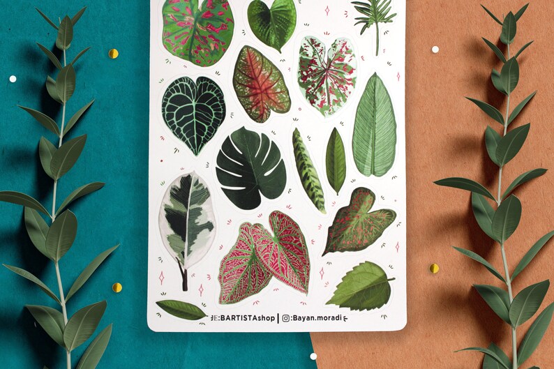 May include: A sheet of stickers featuring various green and pink tropical leaves. The stickers are on a white background with pink and white dots. The text "#BARTISTAshop | @Bayan.moradi" is at the bottom of the sheet.