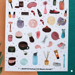 May include: A sheet of stickers featuring various beauty and self-care items, including a face mask, bath salts, a facial roller, a teacup, a bath bomb, a face scrub, and a bottle of essential oil. The stickers are on a white background with a light brown border.