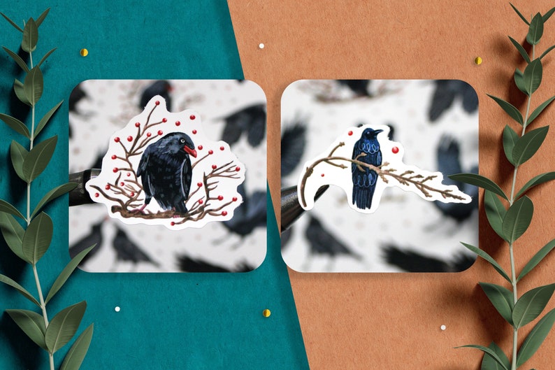May include: Two stickers featuring black birds perched on branches with red berries. The birds are depicted in a realistic style with detailed feathers and beaks.
