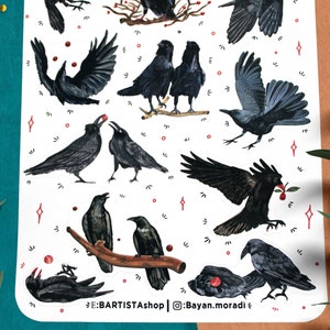 May include: A sheet of stickers featuring black crows in various poses, some with red berries. The stickers are on a white background with red and white stars. The text "E:BARTISTA shop | @Bayan.moradi" is at the bottom of the sheet.