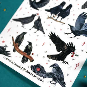 May include: A sheet of stickers featuring black crows in various poses, including flying, perched, and with a red berry in their beak. The stickers are on a white background with red dots and white stars.