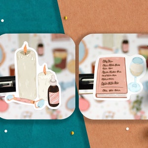 May include: Two sticker sheets with illustrations of self-care items. The first sheet features two white candles, a bottle of essential oil, and a jade roller. The second sheet features a pink notebook with handwritten text, and a glass of white wine.