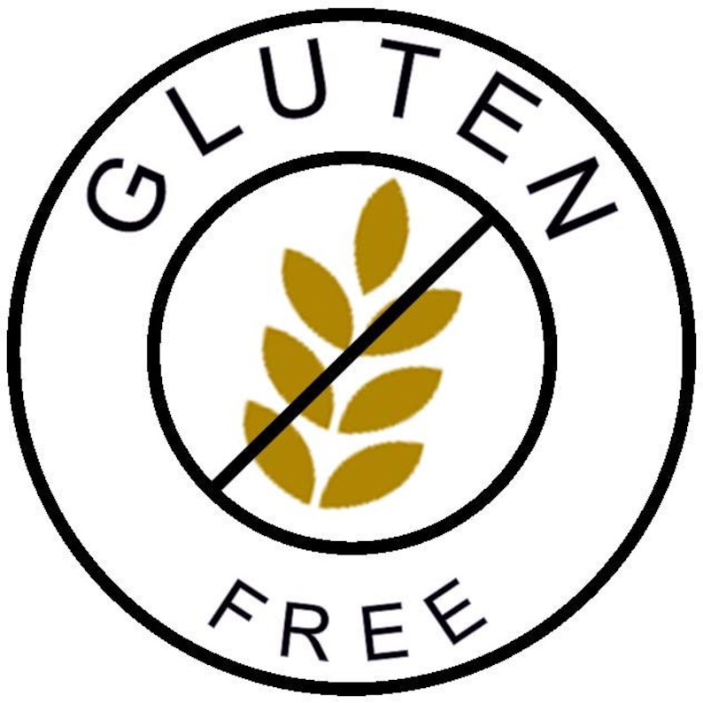 May include: A white circle with a black border and the words "Gluten Free" in black text. A black line crosses out a gold wheat stalk graphic in the center.