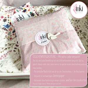 May include: A pink and white floral patterned gift wrap with a white bird and a round sticker that says "inki fabrics Danke!"  The text below the sticker says "GESCHENKVERPACKUNG - Mit extra Liebe verpackt!"  The text below that says "Bei uns wird jede Bestellung mit viel Aufmerksamkeit verpackt. Soll es jedoch etwas mehr sein, dann kannst du gerne unsere Geschenkverpackung dazu buchen: -Pers&ouml;nliche Nachricht von dir an den Beschenkten/die Beschenkte -Verpackt in hochwertigen Seitenpapier - Versendet ohne Rechnung in einem stabilen, wei&szlig;en Versandkarton Hast du Fragen hierzu? Melde dich gern bei uns!"