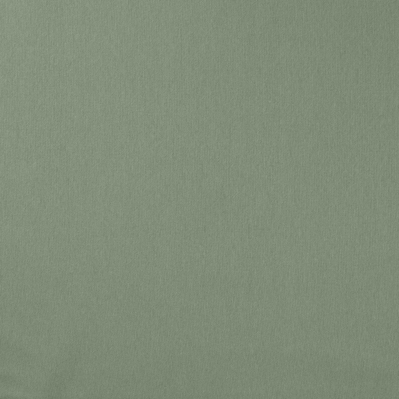 May include: A solid sage green fabric with a visible, fine-grained woven texture. The material displays a consistent, matte finish across the entire surface, showcasing a dense and uniform weave pattern characteristic of a standard textile material.