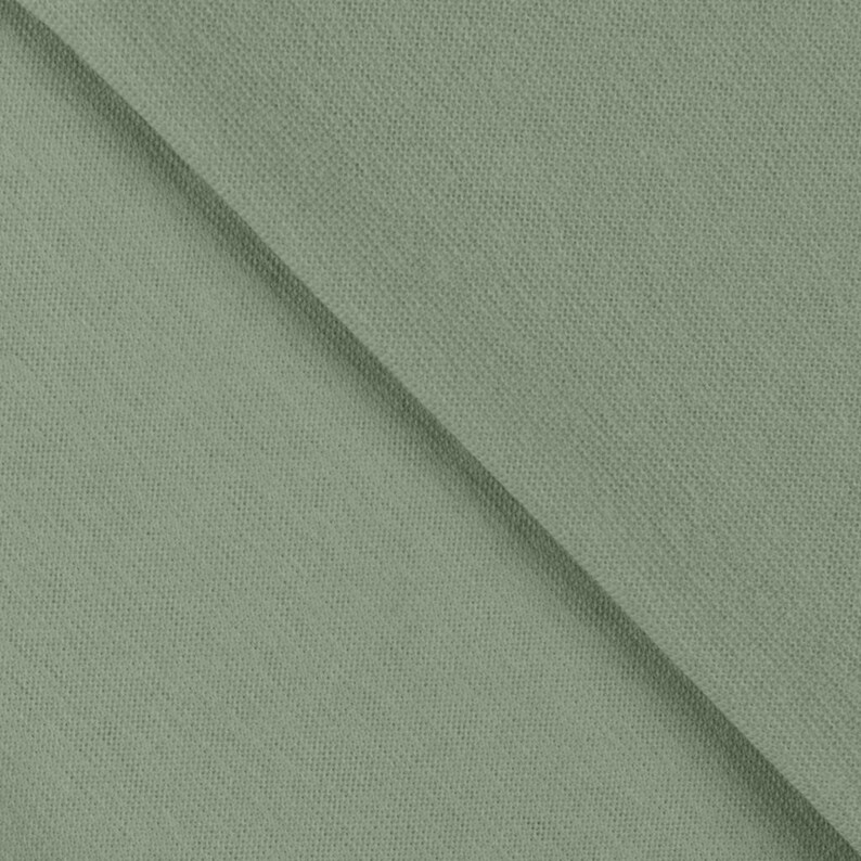 May include: A solid sage green fabric with a visible woven texture. The material features a consistent, muted green tone throughout, displaying a tight, uniform weave pattern that runs diagonally across the frame, creating a clean, flat surface.