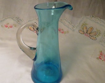 Blue hand blown glass pitcher with applied clear handle