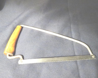 Vintage meat saw with a bakelite handle