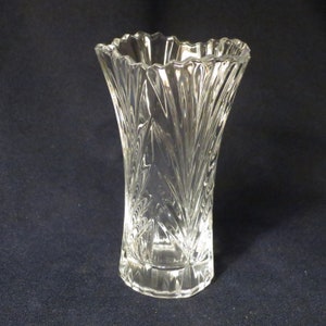 May include: A clear glass vase with a cut crystal design. The vase has a wide mouth and a narrow base.