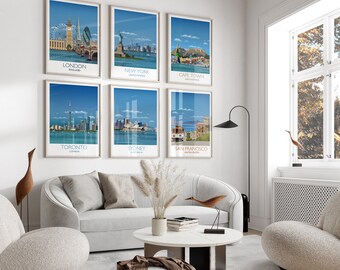 May include: Six framed travel posters featuring iconic cityscapes: London, New York, Cape Town, Toronto, Sydney, and San Francisco. Each poster has a blue sky background and a white border. The posters are displayed on a white wall above a white sofa and chairs.