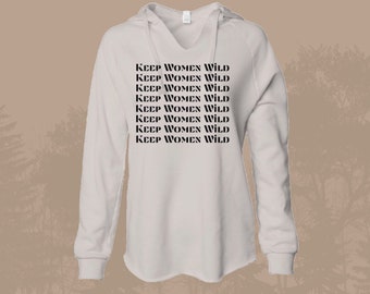 May include: A white hooded sweatshirt with the phrase "Keep Women Wild" repeated in black text.