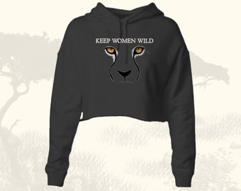 May include: A black cropped hoodie with a white print that says "KEEP WOMEN WILD" and a cheetah face with orange eyes.