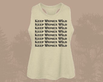 May include: A light beige tank top with the phrase "KEEP WOMEN WILD" repeated in black text.