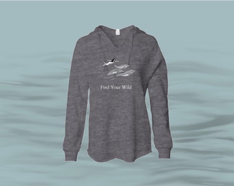 May include: A heather gray hooded sweatshirt with a white graphic of a person swimming with dolphins. The text "Find Your Wild" is printed below the graphic.