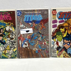May include: Three comic books featuring the New Teen Titans. The covers are colorful and feature various characters from the comic book series. The first comic book is titled "The New Teen Titans" and features a green and yellow background with the characters Starfire, Cyborg, and Beast Boy. The second comic book is titled "The New Teen Titans" and features a brown and orange background with the characters Raven, Robin, and Wonder Girl. The third comic book is titled "New Titans" and features a red and yellow background with the characters Nightwing, Cyborg, and Starfire.