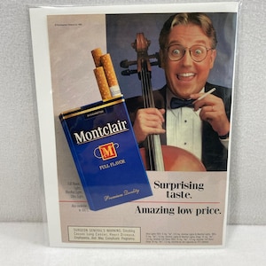 May include: An advertisement for Montclair cigarettes. The image features a blue and gold pack of cigarettes, a man playing a cello, and text that reads "Surprising taste. Amazing low price."