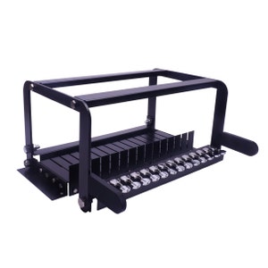 May include: A black soap cutter with a rectangular frame and parallel blades. It features a side handle and a row of silver knobs. The device is designed for cutting soap into bars, with a metric measurement system.