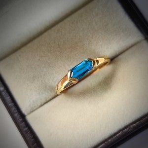 May include: A set of three ceramic mugs with a speckled, matte finish. The mugs are in shades of cream, light brown, and dark brown. Each mug has a simple, minimalist design, perfect for coffee or tea.