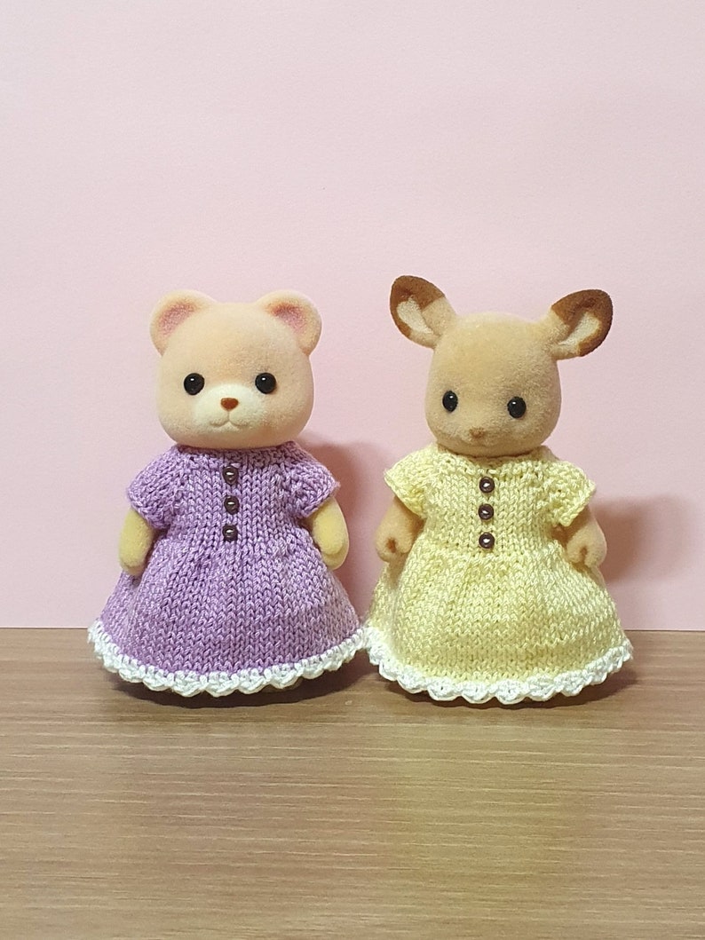 Two Calico Critters mothers in knitted dresses.