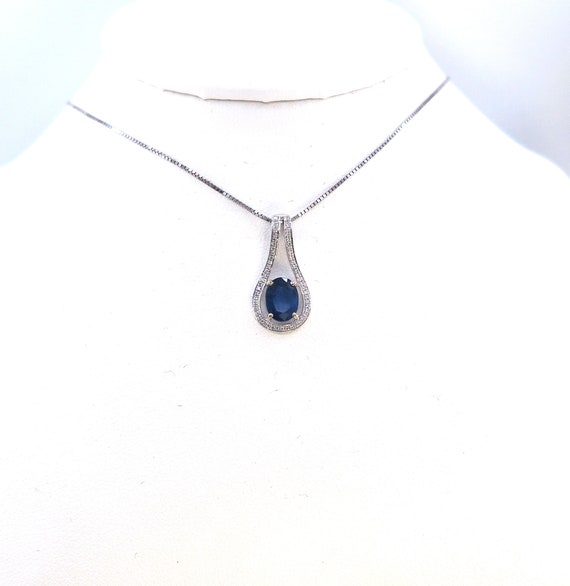 14 K White Gold Slider Pendant featuring Blue Sapphire Oval Shaped Center Diamond
